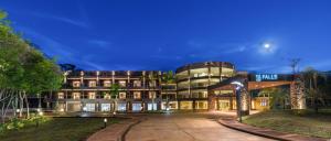 a hotel with a building in front of it at Falls Iguazú Hotel in Puerto Iguazú