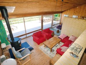 a living room with a red couch and a table at 8 person holiday home in Asnæs in Asnæs +21 photos