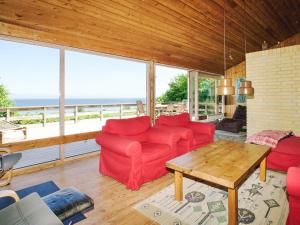 a living room with a red couch and a table at 8 person holiday home in Asnæs in Asnæs