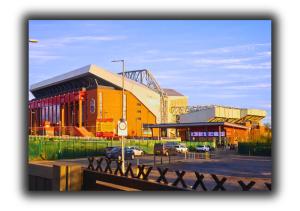 a group of buildings in a city with a street at Kop View Rooms in Liverpool
