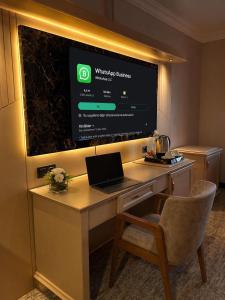 a desk in a hotel room with a laptop on it at EMİRGAN Otel in Bağlık +27 photos
