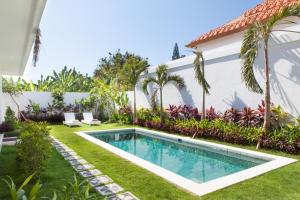 a swimming pool in the yard of a house at Villa Casablanco in Seminyak