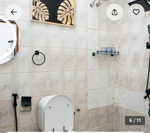 a bathroom with a toilet and a sink at The courtyard Zanzibar in Ngambo