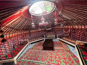 an inside view of an empty arena with a stage at Alima in Ottuk
