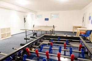 a room with a ping pong table and balls on the floor at TRA7 "Residenz Windrose" - App Reichelt in Niendorf