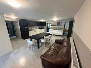 a living room with a couch and a table and chairs at Kwatera pracownicza Leszno in Leszno