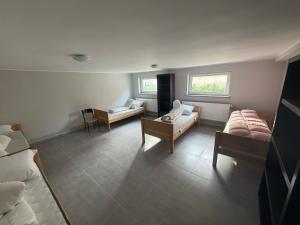 a room with two beds and two tables in it at Kwatera pracownicza Leszno in Leszno