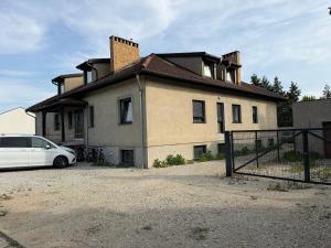 a white car parked in front of a house at Kwatera pracownicza Leszno in Leszno