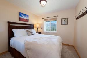 a bedroom with a large bed and a window at East Rim - Unit C12 in Durango
