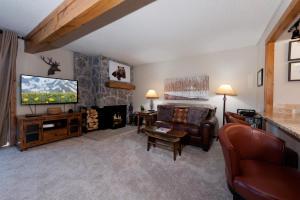 a living room with a couch and a television at East Rim - Unit C12 in Durango