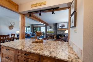 a kitchen with a counter and a living room at East Rim - Unit C12 in Durango