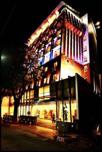 a large building with lights on it at night at The HQ in Vasco Da Gama