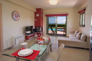 a living room with a glass table and a couch at Trapezaki Bay Cottage in Trapezaki