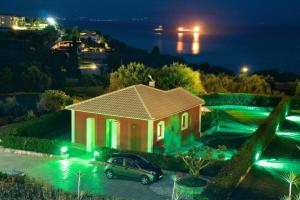 a car parked in front of a house at night at Trapezaki Bay Cottage in Trapezaki