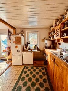 a kitchen with a white refrigerator and a sink at Zimmer in rustikalem alten Haus in Tiefenpölz