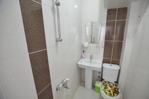 a small bathroom with a toilet and a sink at Cane Motel in Avşa Adası +39 photos