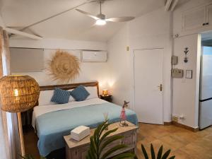 a bedroom with a bed with blue pillows at Les Balcons d'Oyster Pond in Oyster Pond +255 photos