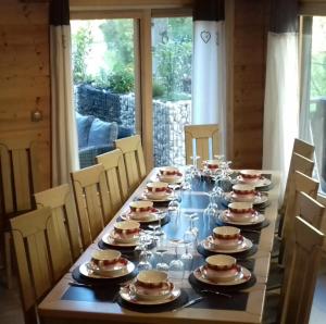 a long table with plates and dishes on it at Chalet Le Plan du Rtia in Morzine +31 photos