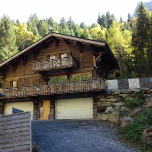 a log house with a balcony and a garage at Chalet Le Plan du Rtia in Morzine