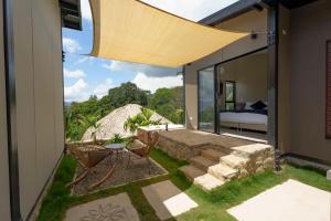 a room with a view of a bed and a patio at Stella club & resort in Hacienda La Cabaña