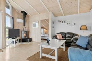 a living room with a couch and a table at LN1954-Hirtshals-Harestien-27 in Hirtshals