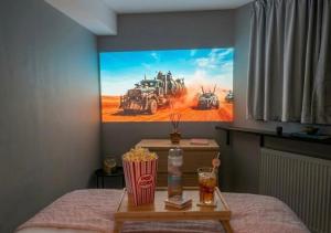 a room with a painting on the wall with a bed at Doux Pavillon - Sauna - Jacuzzi in Tassin-la-Demi-Lune