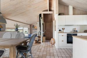 a kitchen with white cabinets and a wooden ceiling at LN1951-Hirtshals-Klitrenden-1 in Hirtshals +22 photos