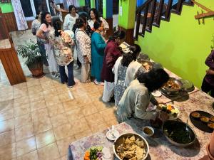a group of people standing around a table with food at Hotel Galaxy View Tower in Nagarkot