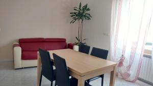 a dining room with a table and chairs and a couch at Sant'Agostino Apartment in Catanzaro