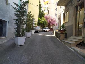 an empty street with cars parked on the side of a building at Sant'Agostino Apartment in Catanzaro