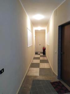 a hallway with a tile floor and a hallway with a door at Sant'Agostino Apartment in Catanzaro