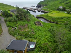 a house on a hill next to a body of water at Fishers Rest in Lybster +48 photos