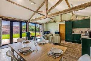 a kitchen and dining room with a table and chairs at Shippon 1 in Radley +21 photos