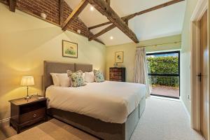 a bedroom with a large bed and a window at Shippon 1 in Radley