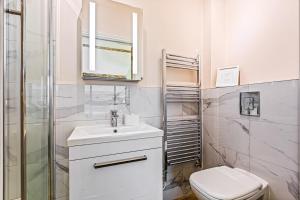 a white bathroom with a sink and a toilet at Shippon 1 in Radley