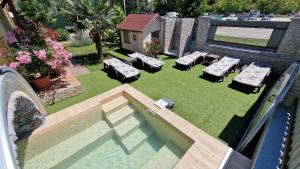 an aerial view of a backyard with a pool and lawnitures at Napsugár Resort in Siófok