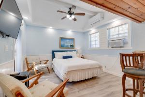 a bedroom with a bed and a ceiling fan at Welcome Matt's - Truman @ Duval Unit B in Key West