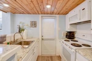 a kitchen with white appliances and a wooden ceiling at Welcome Matt's - Truman @ Duval Unit B in Key West +26 photos