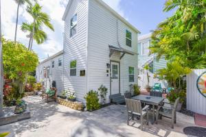 a white house with a table in front of it at Welcome Matt's - Truman @ Duval Unit B in Key West
