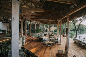 a large wooden deck with tables and chairs at Saseka Tented Camp in Hoedspruit