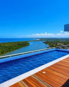 a swimming pool on the roof of a building with a river at Bugan Premium 16 andar - vista mar incrível in Recife