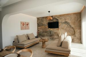 a living room with two couches and a tv at Villas Pasha in Faliraki