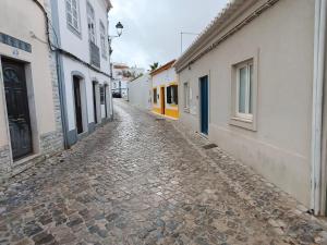 a cobblestone street in a town with buildings at Deluxe 2 Terraces River&Marina View Flat in Ferragudo