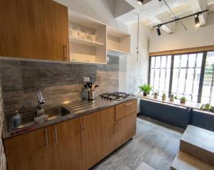 a kitchen with a sink and a stove top oven at Textileria in Pereira