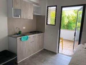 a small kitchen with a sink and a stove at Textileria in Pereira +24 photos