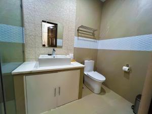 a bathroom with a sink and a toilet at Yuhum Boracay Suites in Boracay