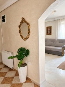a living room with a mirror and a potted plant at Dubai Apartment I in Veternik