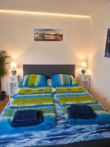a bed with two pillows on it in a bedroom at Seeparadies in Unter Feuchten