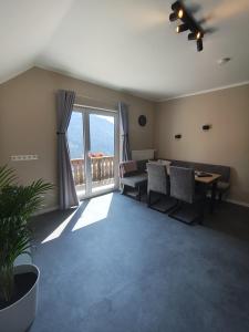 a living room with a couch and a table and a window at Alpenhaus Claudia in Radenthein +9 photos
