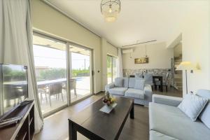 a living room with a couch and a table at Villa Caterina in Skala